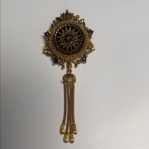 vintage Mid Century Denise brooch with a black onyx/enamel center and a tassel